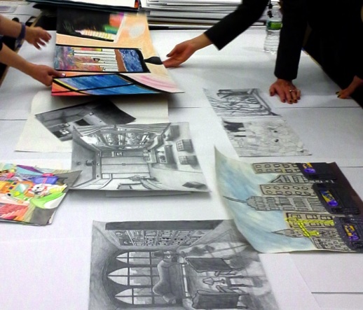 Student Art Program submissions laid out for selection.
